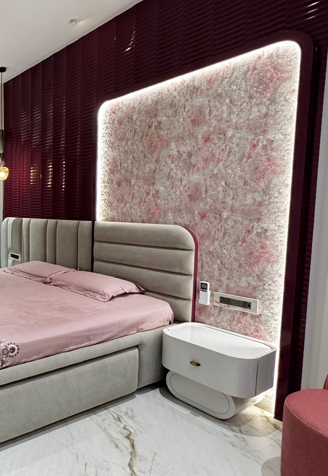 Backlit pink textured feature panel with maroon fluted panelling